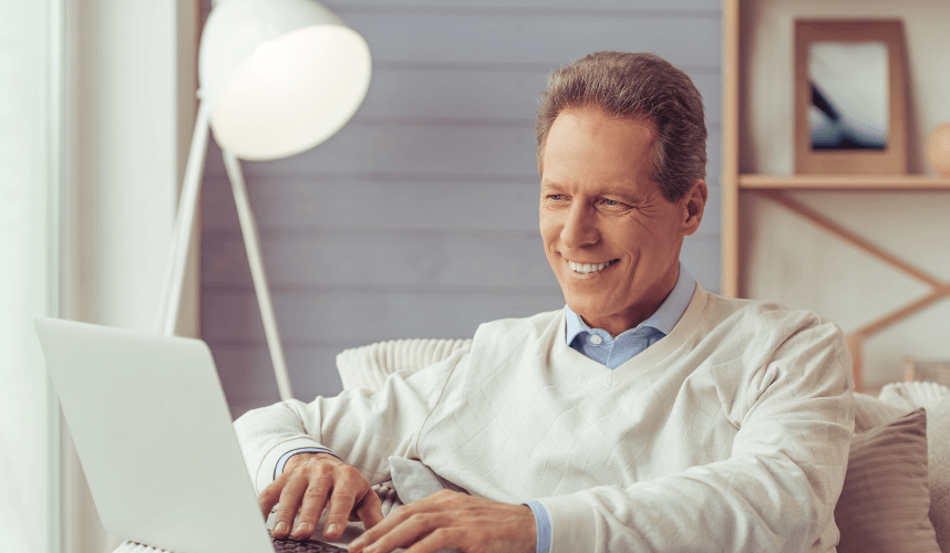 Man looking at computer smiling