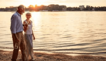 couple walking next to lake